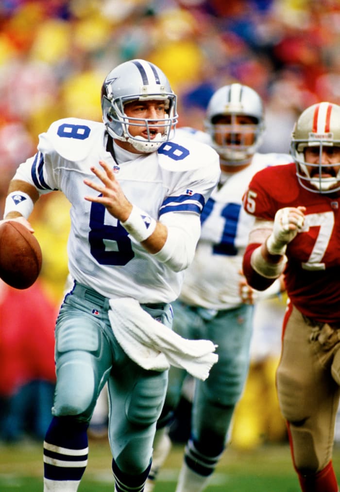 Jan 17, 1993; San Francisco, CA, USA; FILE PHOTO; Dallas Cowboys quarterback Troy Aikman (8) scrambles under pressure from San Francisco 49ers defensive end Kevin Fagan (75) during the 1992 NFC Championship game at Candlestick Park. Mandatory Credit: Peter Brouillet-USA TODAY NETWORK